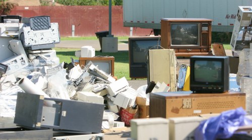 Workers loading waste into a skip bin